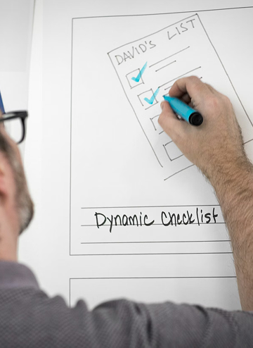 Person marking blue checkboxes on a whiteboard titled 'David's List' with text 'Dynamic Checklist' below.